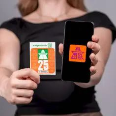 Ręce trzymają naklejkę i smartfon z aplikacją. Oba pokazują symbol autostrady i cyfrę 25, nawiązując do winiety szwajcarskiej.